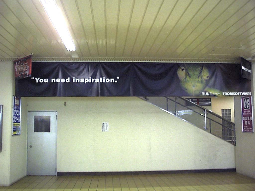 hanging banner of a cricket-like insect admist a dark background, hanging from a station ceiling, with a caption saying 'you need inspiration.' and 'RUNE from FROM SOFTWARE' in the bottom right. it appears to be hanging in front of a stairway, above a door that leads to lockers.